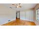 This is a bedroom that has parquet floors, two closets and a window for natural lighting with an overhead ceiling fan at 461 Wilford Ave, Longwood, FL 32750