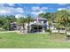 Stately two-story home boasts manicured lawn, palm trees, and traditional architectural details at 980 Geryl Way, Deland, FL 32724