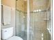 Tiled bathroom featuring a shower with glass door and accent tiling at 11630 Flynn Ct, Winter Garden, FL 34787