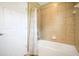 Neutral bathroom with a combined shower and tub, complemented by tiled walls at 11630 Flynn Ct, Winter Garden, FL 34787
