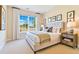 Comfortable bedroom with a plush bed, decorative pillows, neutral decor, and a large window overlooking the yard at 11630 Flynn Ct, Winter Garden, FL 34787