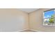 Empty room with neutral-colored walls, carpet, and a window providing natural light at 11630 Flynn Ct, Winter Garden, FL 34787
