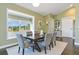 Elegant dining room featuring a large window, hardwood floors, and a stylish table set for six at 11630 Flynn Ct, Winter Garden, FL 34787