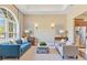 Staged living room featuring comfortable seating, modern decor and stainless steel fridge at 11630 Flynn Ct, Winter Garden, FL 34787
