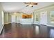 Spacious living room with rich hardwood floors, vaulted ceilings, and seamless access to the kitchen at 11630 Flynn Ct, Winter Garden, FL 34787