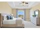 Staged bedroom with a large window view, king bed, side table, and dresser at 11630 Flynn Ct, Winter Garden, FL 34787