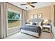 Beautiful primary bedroom with a large window and sophisticated furnishings at 11630 Flynn Ct, Winter Garden, FL 34787
