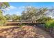 Spacious backyard featuring a wood fence and mature trees at 1220 Rolling Ln, Casselberry, FL 32707
