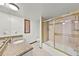 Bright bathroom with tile floors, granite countertop, and shower over tub at 1220 Rolling Ln, Casselberry, FL 32707