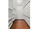 Walk-in closet featuring custom shelving and hardwood floors at 1220 Rolling Ln, Casselberry, FL 32707