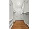 Walk-in closet featuring custom shelving and hardwood floors at 1220 Rolling Ln, Casselberry, FL 32707