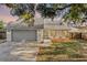 Charming exterior featuring a manicured lawn, well-maintained driveway, and gray accents at 1220 Rolling Ln, Casselberry, FL 32707