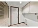 Functional laundry room boasts built-in cabinets and tile flooring at 1220 Rolling Ln, Casselberry, FL 32707