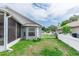 Landscaped backyard view with a screened-in patio and gray siding at 13624 Springtide Ct, Orlando, FL 32826