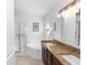 Bright bathroom featuring a soaking tub, glass shower and double vanity with granite countertops at 13624 Springtide Ct, Orlando, FL 32826
