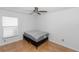 Bedroom with tile floors, ceiling fan, and a bed frame with mattress at 13624 Springtide Ct, Orlando, FL 32826