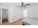 Bedroom featuring tile floors, ceiling fan, closet, and a window at 13624 Springtide Ct, Orlando, FL 32826