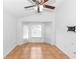 Spacious bedroom with a ceiling fan, big window with tile floor and wall-mounted tv at 13624 Springtide Ct, Orlando, FL 32826
