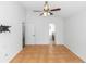 Spacious bedroom with a ceiling fan, big window with tile floor and view into the bathroom at 13624 Springtide Ct, Orlando, FL 32826