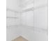 Walk-in closet with white wire shelving, offering ample storage space and organization at 13624 Springtide Ct, Orlando, FL 32826