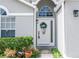Beautiful front door with decorative wreath and sidelights with nice garden at 13624 Springtide Ct, Orlando, FL 32826