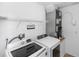 The laundry room includes a washer, dryer, and wire rack shelving at 13624 Springtide Ct, Orlando, FL 32826