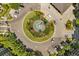 Overhead shot of a luxurious condo roundabout featuring a central water fountain and lush landscaping at 14501 Grove Resort Ave # 1441, Winter Garden, FL 34787
