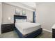 Comfortable bedroom with blue accents, featuring a large bed and modern decor at 14501 Grove Resort Ave # 1441, Winter Garden, FL 34787