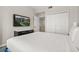 Bright bedroom with large TV, closet space, neutral walls, and plush bed at 14501 Grove Resort Ave # 1441, Winter Garden, FL 34787