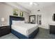 This bedroom features two modern nightstands, matching lamps and vibrant artwork, creating a luxurious retreat at 14501 Grove Resort Ave # 1441, Winter Garden, FL 34787