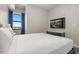Bright bedroom with a view, featuring a TV and ample natural light at 14501 Grove Resort Ave # 1441, Winter Garden, FL 34787