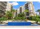 A courtyard view shows a tiered water feature, mature palms and landscaping, and multi-story condos at 14501 Grove Resort Ave # 1441, Winter Garden, FL 34787