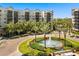 Upscale condominium with water fountain, lush greenery, and beautiful landscaping at 14501 Grove Resort Ave # 1441, Winter Garden, FL 34787