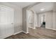 Spacious hallway with wood flooring and access to multiple rooms at 14501 Grove Resort Ave # 1441, Winter Garden, FL 34787