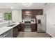 Modern kitchen featuring stainless steel appliances and dark wood cabinetry at 14501 Grove Resort Ave # 1441, Winter Garden, FL 34787
