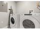 Functional laundry room equipped with a washer and dryer for convenience at 14501 Grove Resort Ave # 1441, Winter Garden, FL 34787