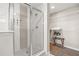 Bright bathroom with glass-enclosed shower, white tiled walls and shelving, and a spacious closet area at 14501 Grove Resort Ave # 1441, Winter Garden, FL 34787