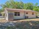 The backyard showcases an exterior storage unit, air conditioning unit, and back door at 1531 Jefferson Dr, Mount Dora, FL 32757