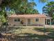 A cozy single-story home with a well-kept front yard and charming facade under the bright blue sky at 1531 Jefferson Dr, Mount Dora, FL 32757