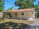 Inviting single-story home featuring a charming porch and well-maintained lawn on a sunny day at 1531 Jefferson Dr, Mount Dora, FL 32757