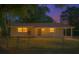 Charming home with a cozy front yard and welcoming entrance, illuminated by warm light at dusk at 1531 Jefferson Dr, Mount Dora, FL 32757