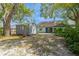 Backyard shed with an open backyard with trees and grass with the house in the background at 212 Hound Run Pl, Casselberry, FL 32707