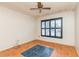 A modest room with a ceiling fan, neutral walls and terracotta floors with black window shutters at 212 Hound Run Pl, Casselberry, FL 32707