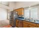Modern kitchen featuring stainless steel appliances, wood cabinetry, and a spacious design for efficient meal preparation at 212 Hound Run Pl, Casselberry, FL 32707