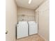A small laundry room area features a washer, dryer, and wire shelving for storage at 212 Hound Run Pl, Casselberry, FL 32707