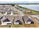 Stunning aerial view of lakeside homes featuring solar panels, manicured lawns, and neighborhood walking paths at 260 Lake Smart Cir, Winter Haven, FL 33881
