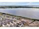 Aerial view of homes on a lakefront property, many with solar panels and close to the water and walking trail at 260 Lake Smart Cir, Winter Haven, FL 33881