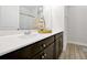 Bathroom featuring a double sink, dark cabinetry, and a decorative sailboat at 260 Lake Smart Cir, Winter Haven, FL 33881