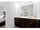 Bathroom featuring a double vanity sink, spacious mirror, and tile flooring at 260 Lake Smart Cir, Winter Haven, FL 33881