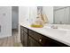 Bathroom featuring a double sink, dark cabinetry, and a decorative sailboat at 260 Lake Smart Cir, Winter Haven, FL 33881